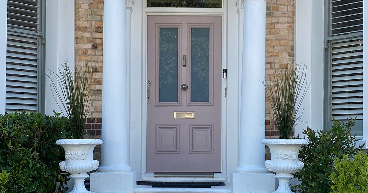 Pink front door to a period property in London