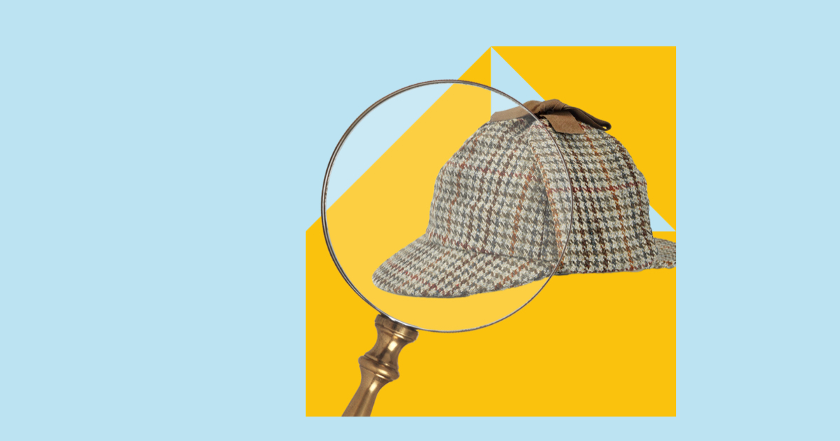 Magnifying glass over a Sherlock Holmes style hat
