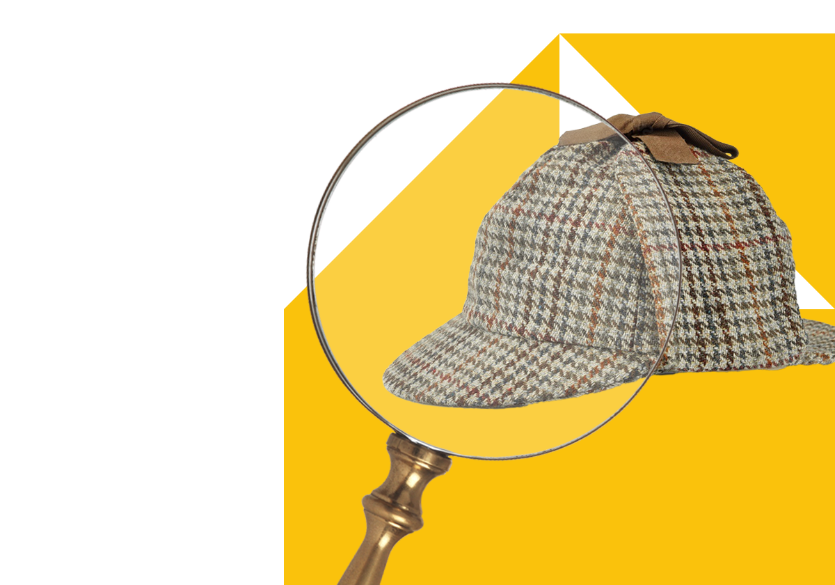 Magnifying glass over a Sherlock Holmes style hat